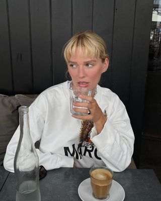 Woman sitting and drinking water