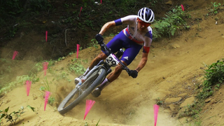 Thomas Pidcock of Team Great Britain bikes rides through a tight dusty corner in preparation for the mountain biking live streams at Olympics 2024