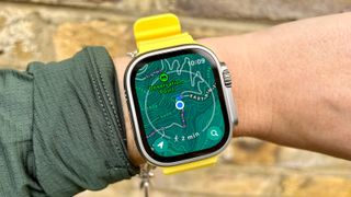 The Apple Watch Ultra on a wrist showing the new Map view for hikers.