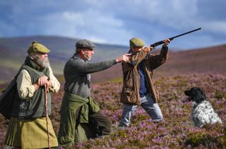 AVIEMORE, SCOTLAND - AUGUST 12: Head keeper Graeme MacDonald leads a shooting party at the beginning of a new shooting season on a grouse moor at the Alvie Estate on August 12, 2017 in Aviemore, Scotland. The Glorious 12th signals the start of the grouse shooting season, it has been an integral part of the countryside calendar for decades with enthusiasts travelling from all over the world to shots on Scotlands finest estates. (Photo by Jeff J Mitchell/Getty Images)