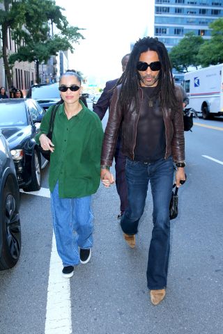 Zoë Kravitz with Lenny Kravitz wearing an oversized green button-up shirt with baggy jeans and black sneakers in New York City September 2024