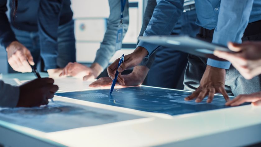 Engineer, Scientists and Developers Gathered Around Illuminated Conference Table in Technology Research Center, Talking, Finding Solution and Analysing Industrial Engine Design. Close-up Hands Shot