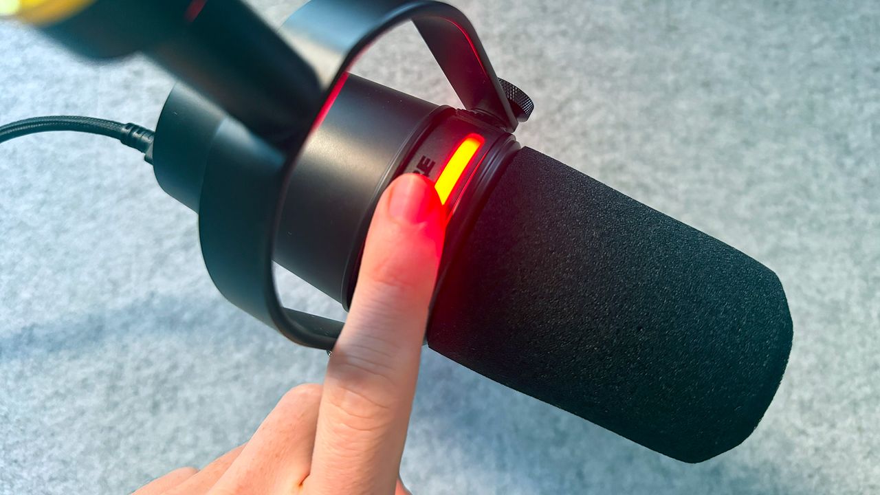 The LED strip on the Shure MV7+ turned red as a reviewer presses a finger to it