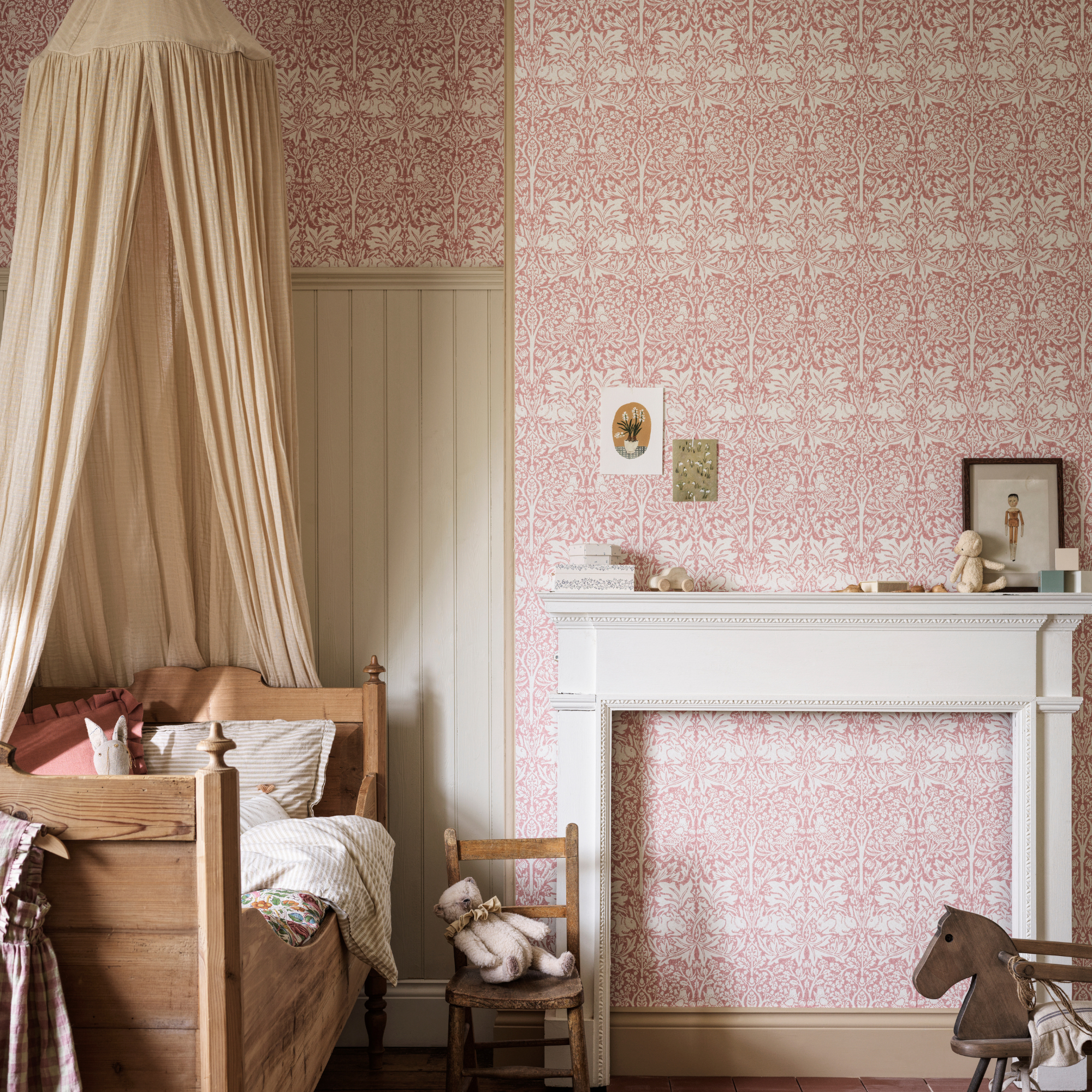 a kids room with william morris brer rabbit wallpaper and wooden day bed