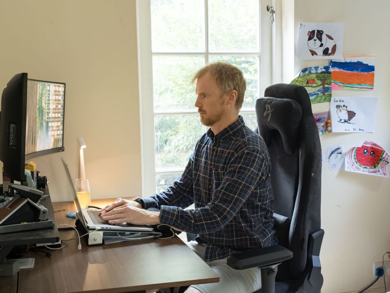 Man sat on the Arozzi Vernazza Supersoft gaming office chair in a home office room