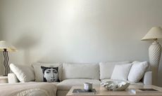 White room with white couch and contemporary patterned cushions