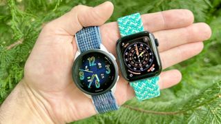 Close-up of the Garmin Forerunner 165 next to the Apple Watch SE 3