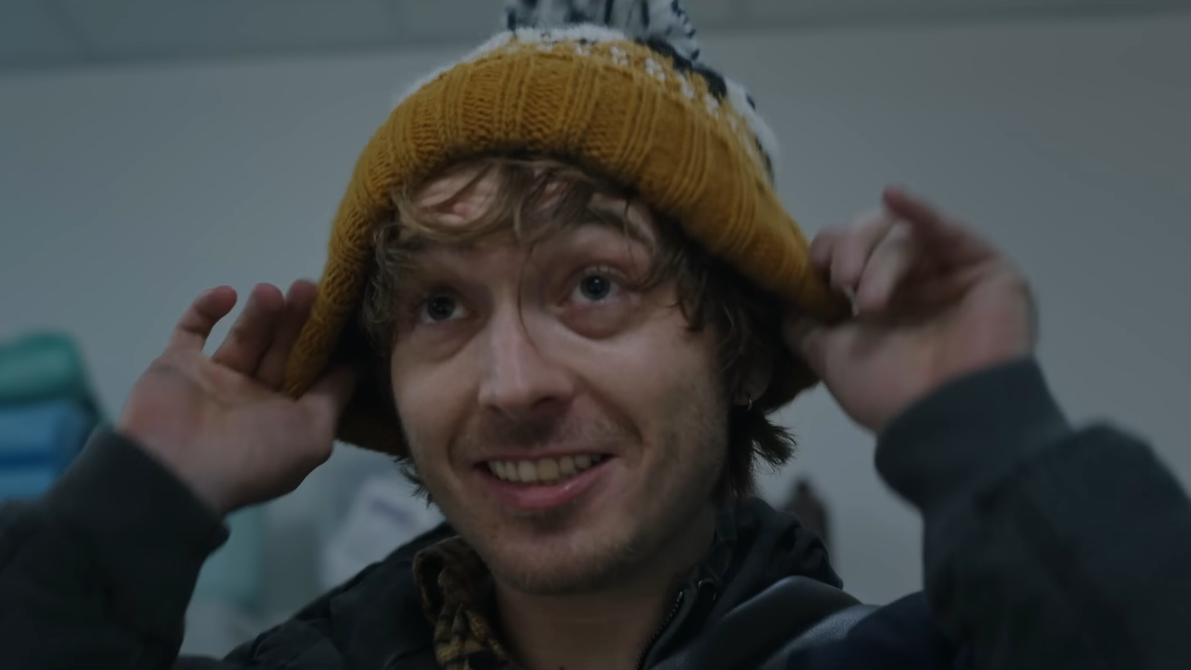 Resident Evil (2026) trailer still - Austin Abrams pulling on a touque