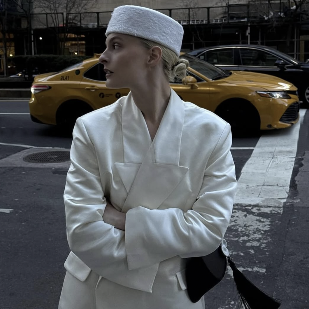 woman in white hat and suit