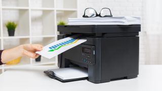 printer on a table printing a document