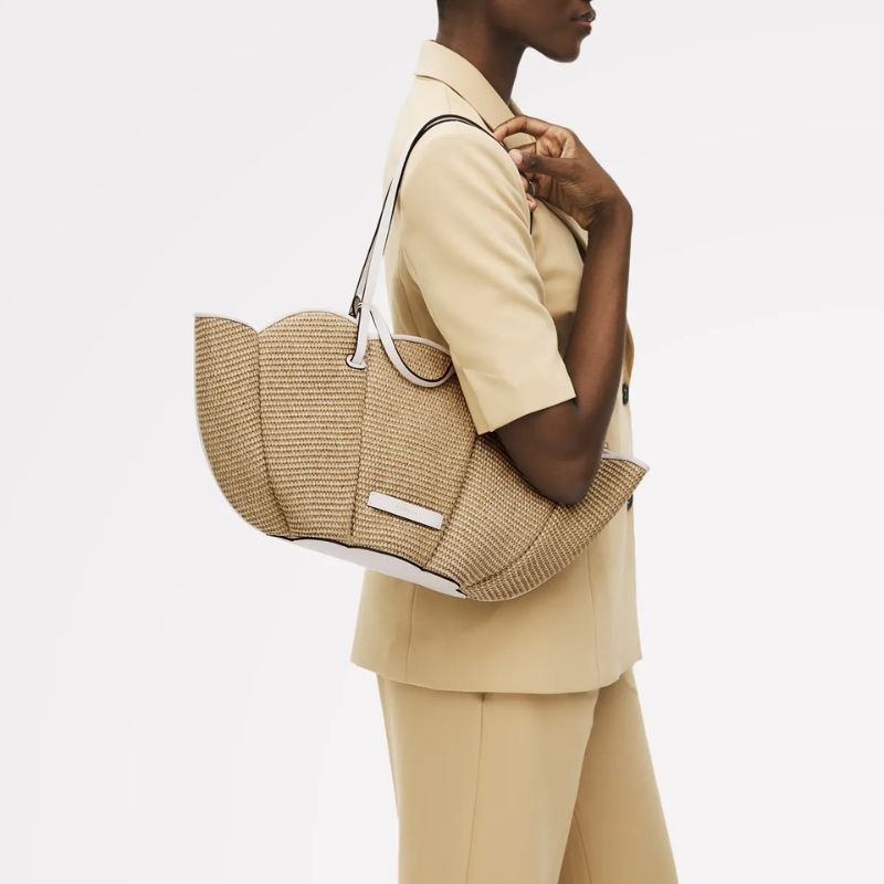 Radley The Lily Raffia Large Open Top Tote, carried by a model 