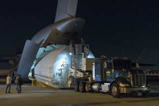 The Space Telescope Transporter for Air, Road and Sea, a specially designed shipping container that held the optical telescope and integrated science instrument module of NASA's James Webb Space Telescope, is unloaded from a U.S. military C-5 Charlie aircraft at Los Angeles International Airport on Feb. 2, 2018.