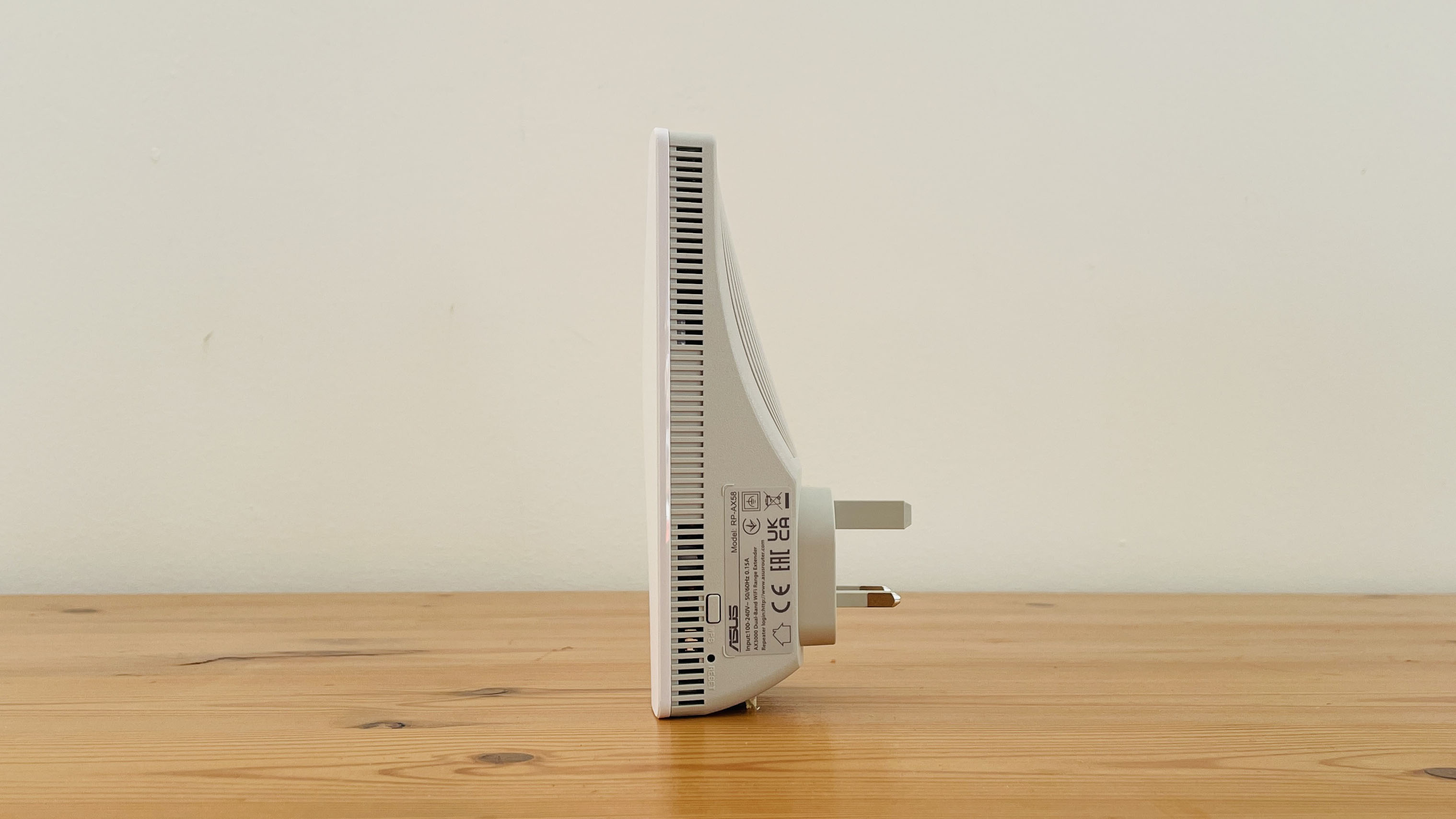 Asus RP-AX58 on a wooden table