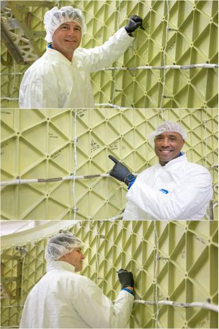 a stack of three images shows three individual men in white coats and hair nets signing or indicating their signature on the inside of a pale green metal shell with structural support lattice.