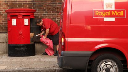 Royal Mail postie emptying a letter box