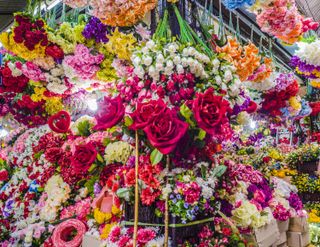 Colorful artificial flowers for sale at a stall in the Chatuchak Weekend Market in Bangkok, Thailand