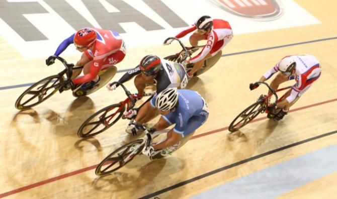 Britain's Jason Kenny has to go the long way round to win his heat in round one of the Keirin