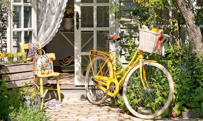 garden area with bicycle and yellow chair