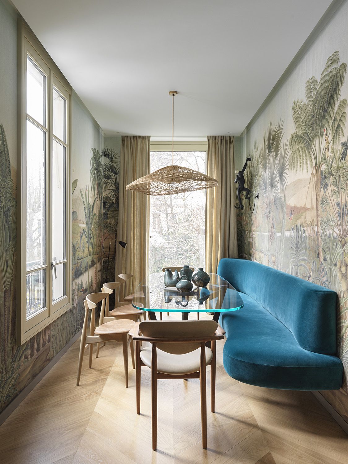 built in banquette in a modern dining space with a big mural on the wall