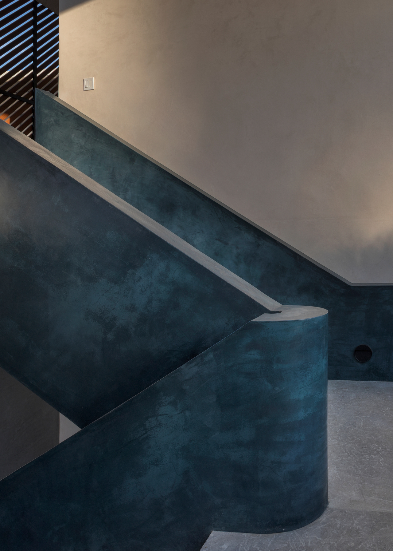Blue concrete staircase rail