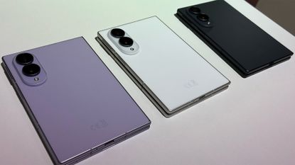 Three Samsung Galaxy Z Fold 8 smartphones on display in a row, in lilac, white, and black color formats.