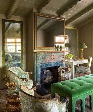 library with khaki brown walls fireplace and green ottoman