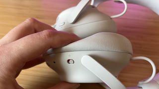 Padding on Alienware Pro Wireless headset being pushed by reviewer hand to show depth