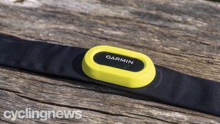 A Garmin HRM Pro heart rate monitor sits on a bench