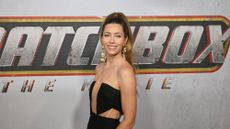 Jessica Biel standing in front of Matchbox The Movie logo