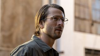 Glen Powell wearing glasses and collared shirt with long-ish hair in Netflix&#039;s Hit Man