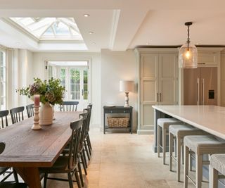 large open plan kitchen diner with large kitchen island and stone flooring