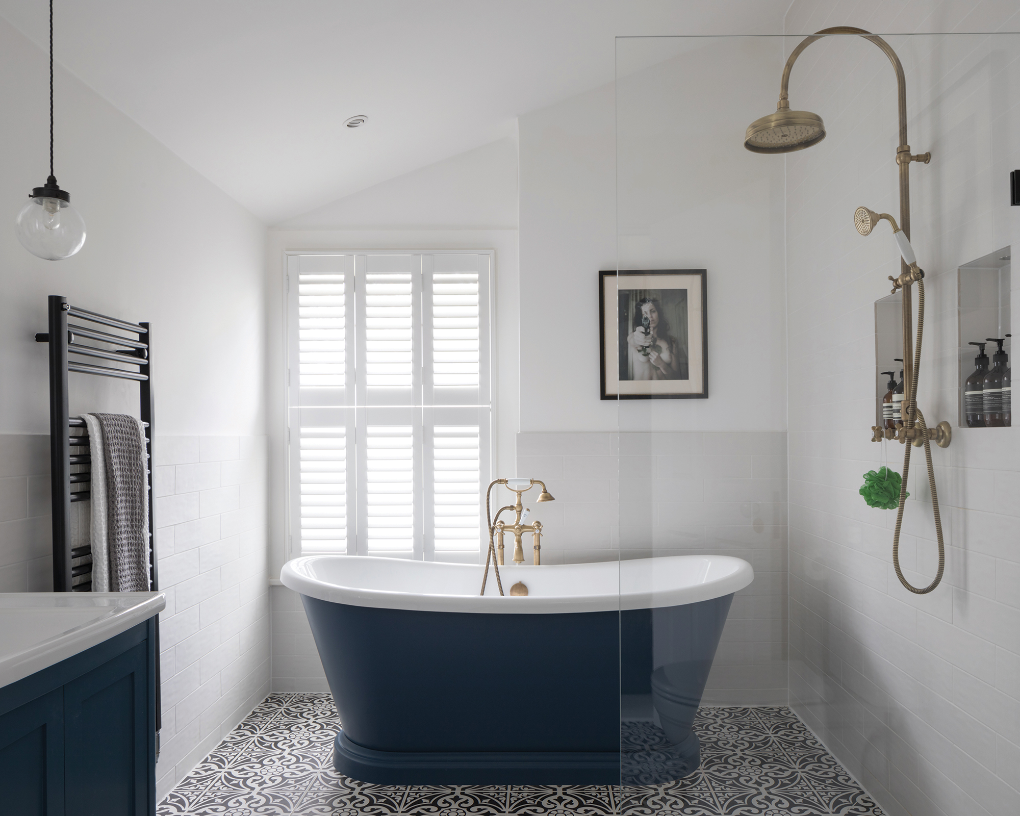 Small bathroom ideas showing a brushed brass shower over a freestanding bath