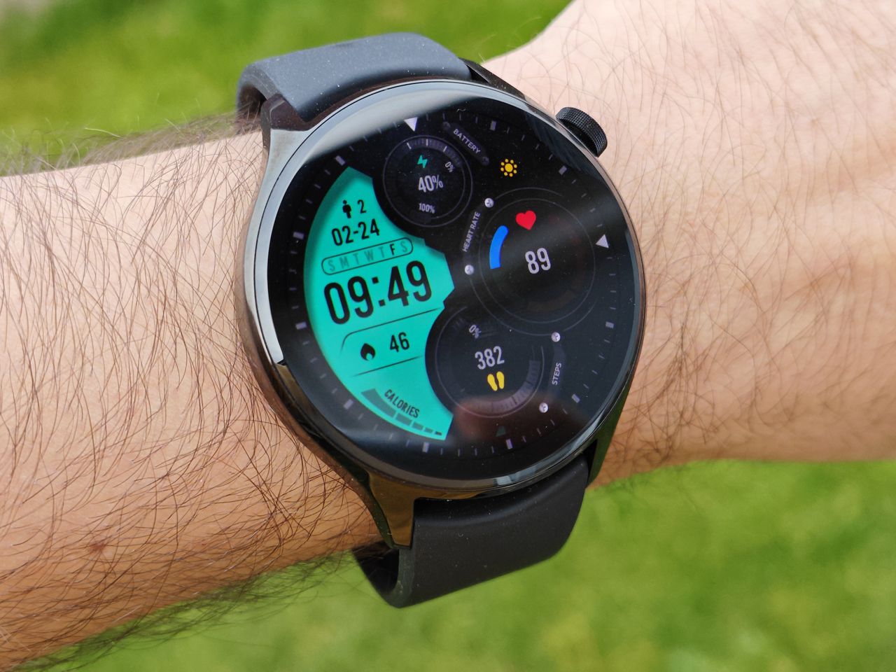 The Xiaomi Watch S1 Pro worn with a green background