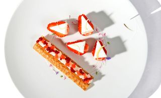 White surface, white plate, pastries dish, including strawberry's and cream by Camille Lesecq