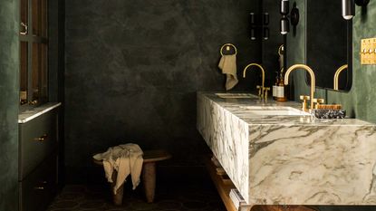 a green bathroom with limewash walls