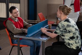 Matty and Amy chatting in a prison visitor room in Emmerdale 