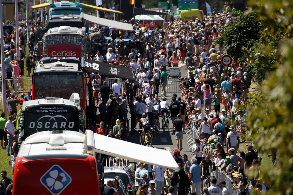 Team buses line up at the finish, waiting for the riders to arrive.