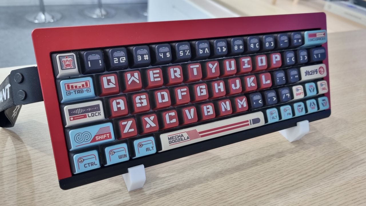 Various custom Godzilla keycaps and boxes at the KeyTok booth, 2025