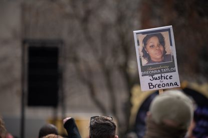 Protester with "Justice for Breonna Taylor" sign