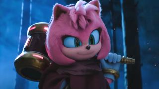 Amy Rose smirks as she holds her hammer in the dark woods in Sonic the Hedgehog 3.