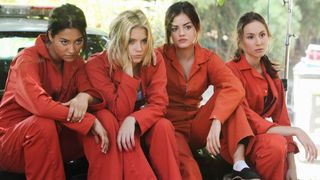 The cast of Pretty Little Liars in orange jump suits
