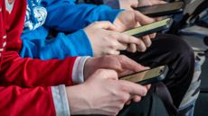 Young arms and hands holding phones