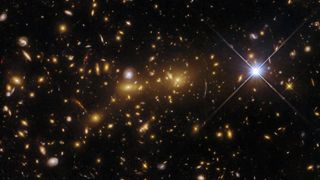 hubble space telescope photo of dozens of distant galaxies in deep space