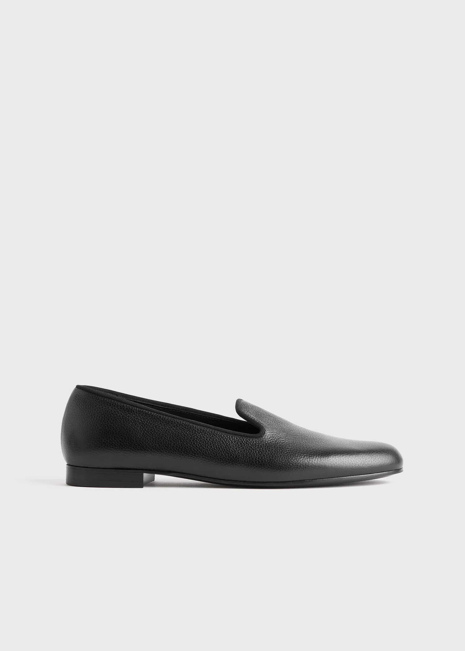 A pair of black Toteme loafers.
