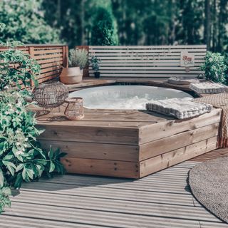 garden area with hot tub deck and wooden flooring