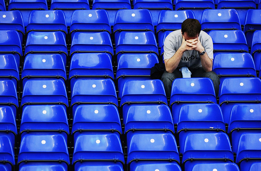 A West Ham United fan sitting alone in the stands looks dejected after his team is relegated after the FA Barclaycard Premiership match between Birmingham City and West Ham United held on May 11, 2003 at St Andrews in Birmingham, England. The match ended in a 2-2 draw. 