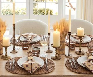 Candles on a Thanksgiving dinner table.