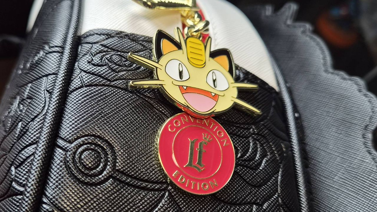 Close up of the Meowth keychain as found on the Team Rocket Cameo Mini Backpack.