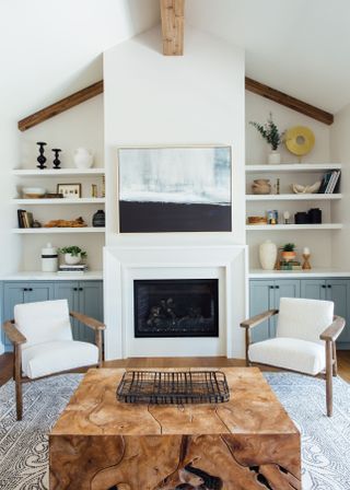 white living room with armchairs and vaulted ceiling