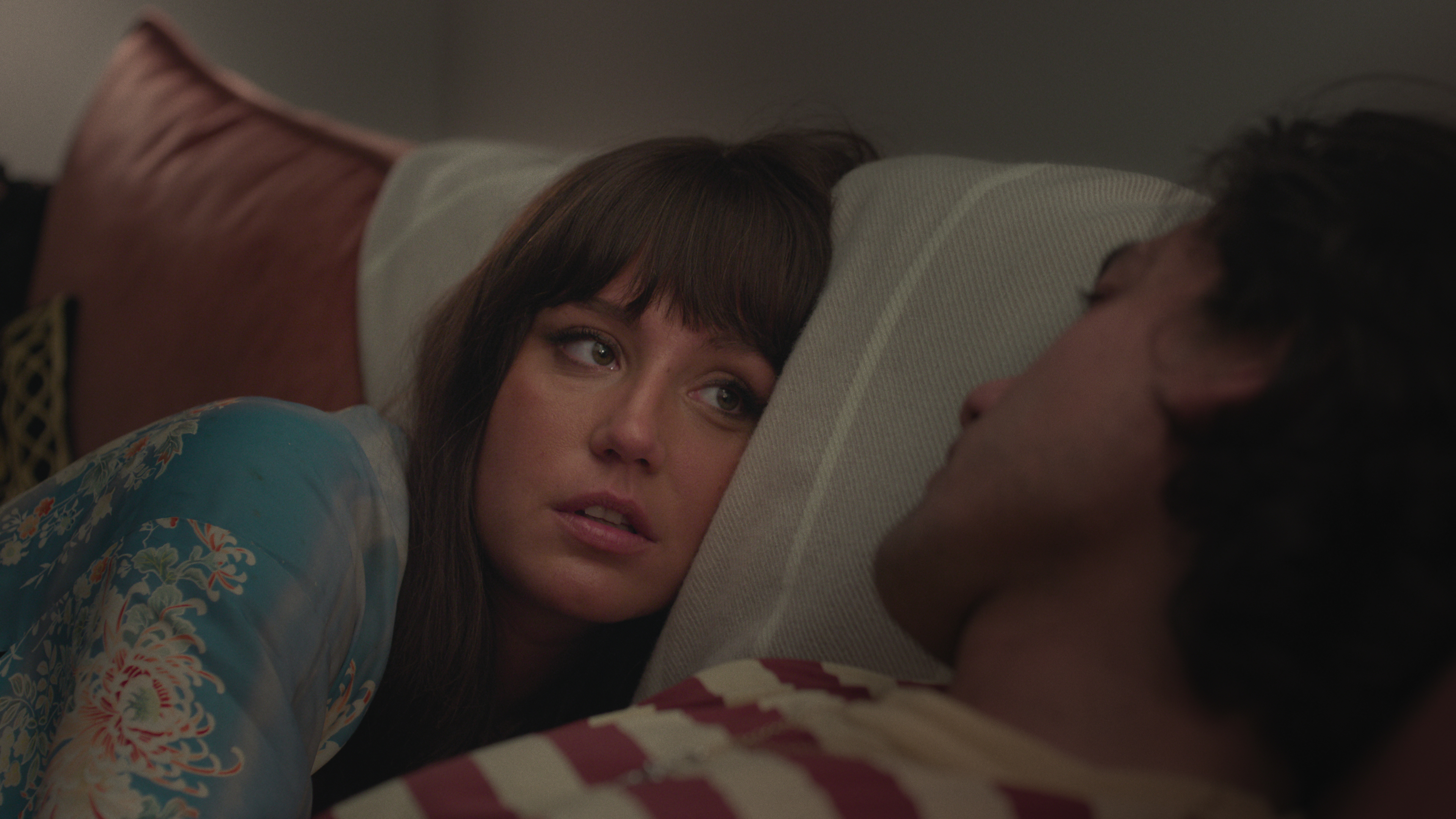 adèle Exarchopoulos speaking to will sharpe in bed in a still from too much